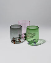 product_hover::Group of Ornamental by Lameice Green & Lilac, Pink & Green and Gray & Amber Transparent Eye Candy Cocktail Glasses on light color background.