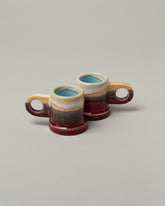 Group of Echo Park Pottery by Peter Shire Ruby Double Dip Espresso Cups on light color background.