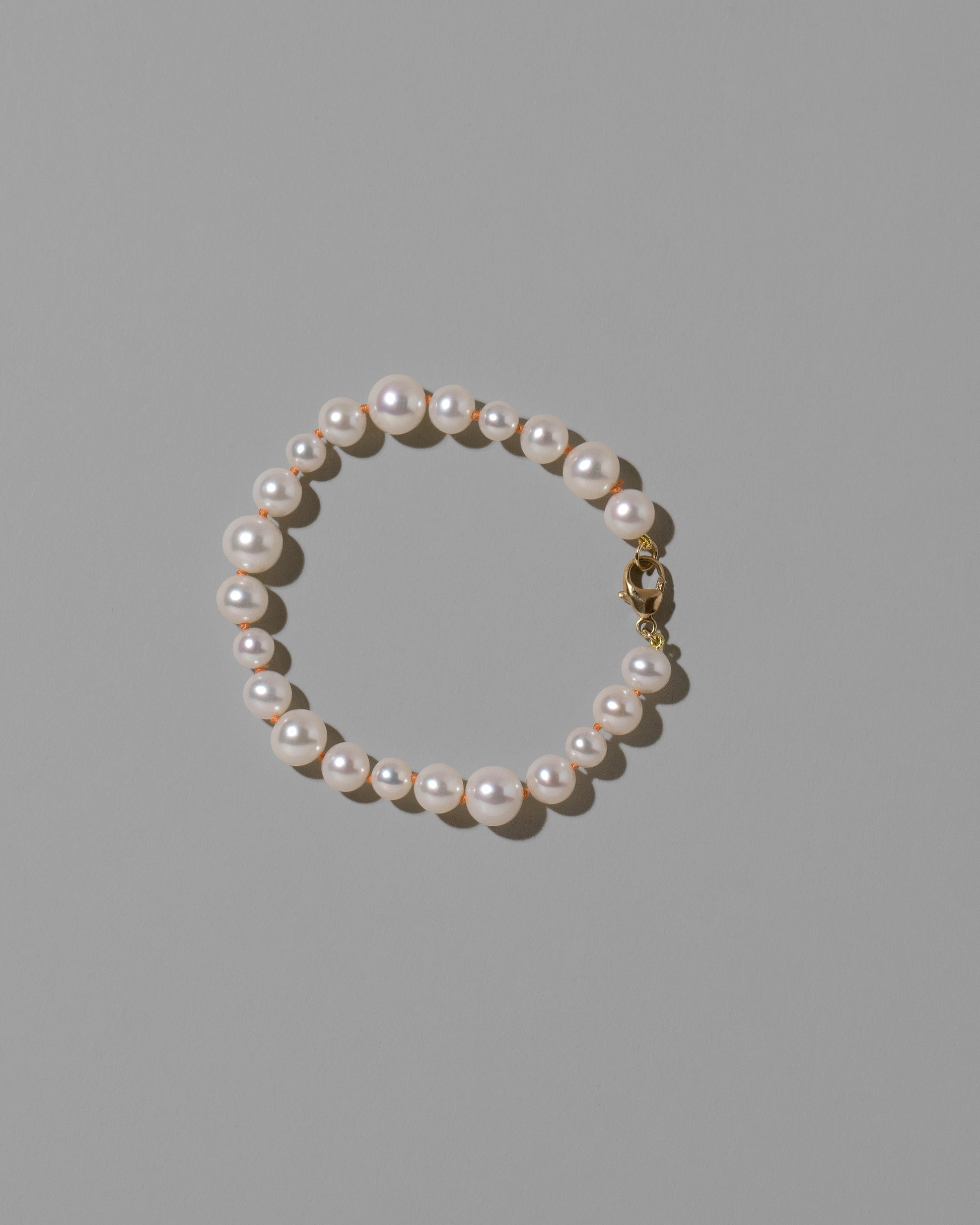 Terracotta Clay Thread Bubble Pearl Bracelet on light color background.