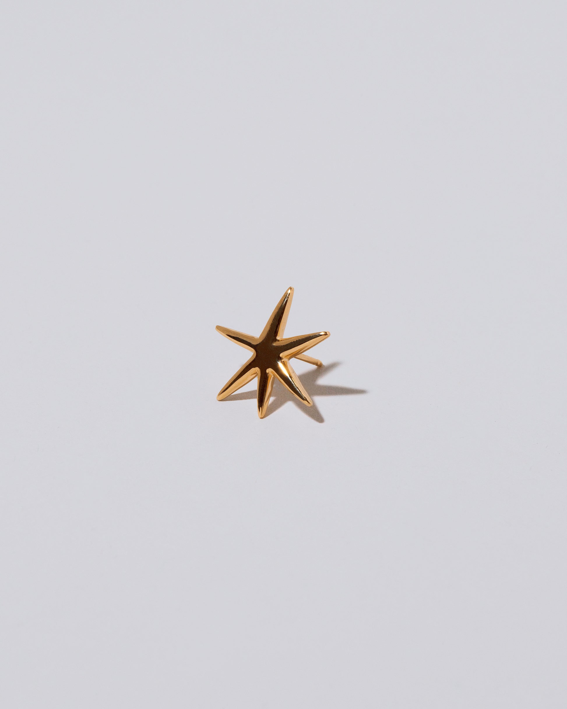 Verve Six Point Star Stud Earrings on light color background.