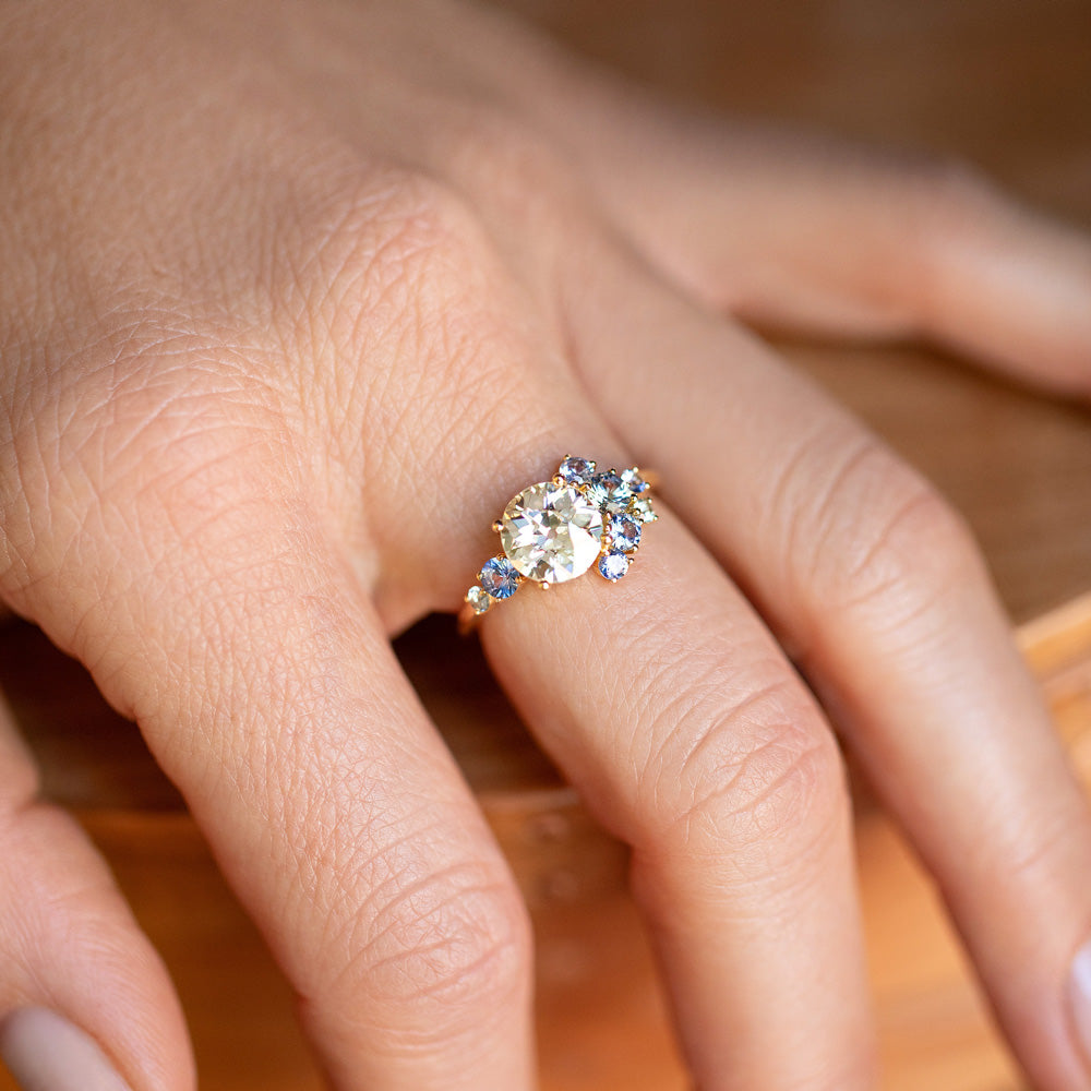 product_details::Closeup details of the Diamond & Sapphire Vega Ring on model.