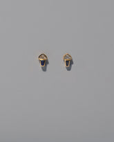 Vela Earrings on light color background.