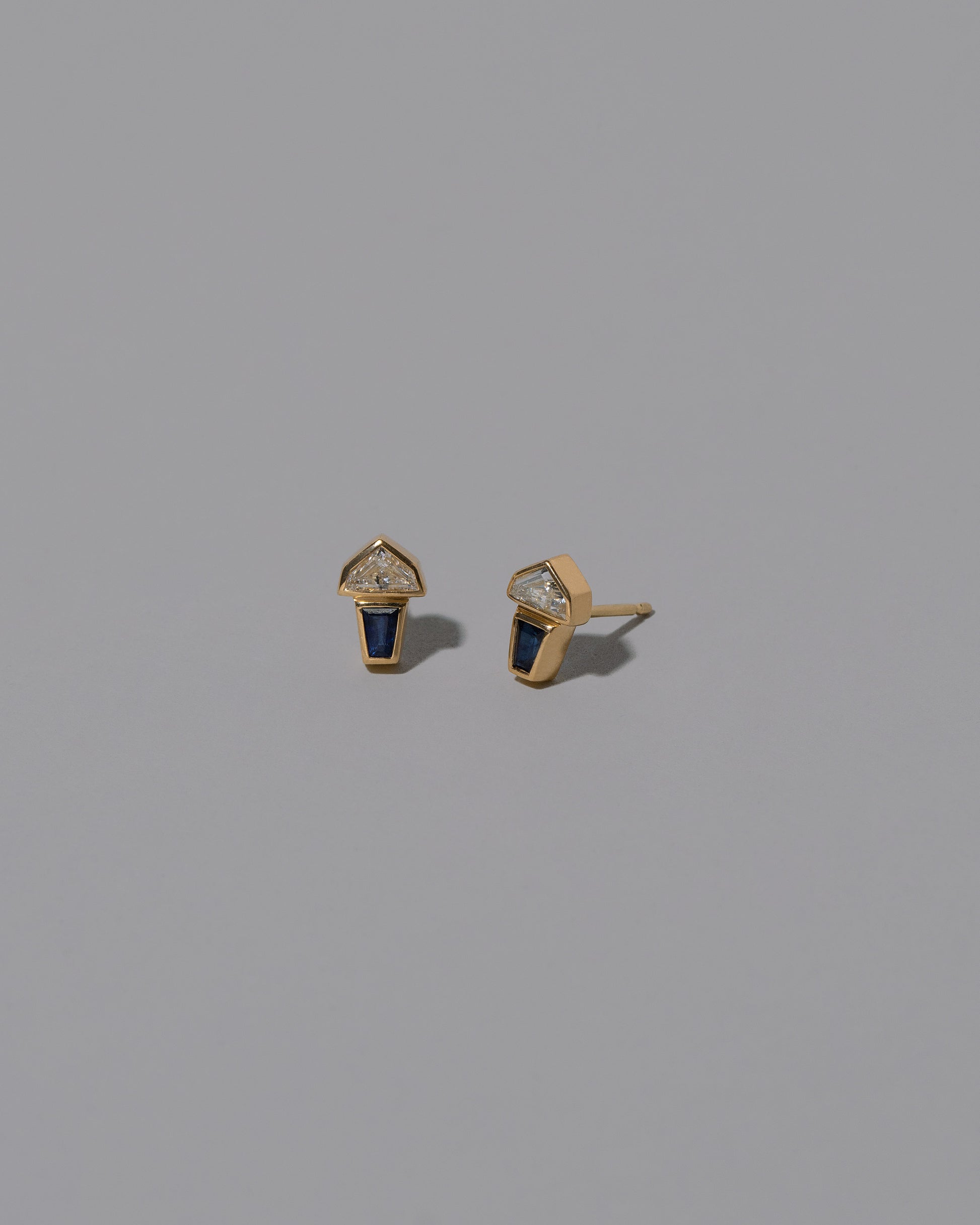 View from the side of the Vela Earrings on light color background.