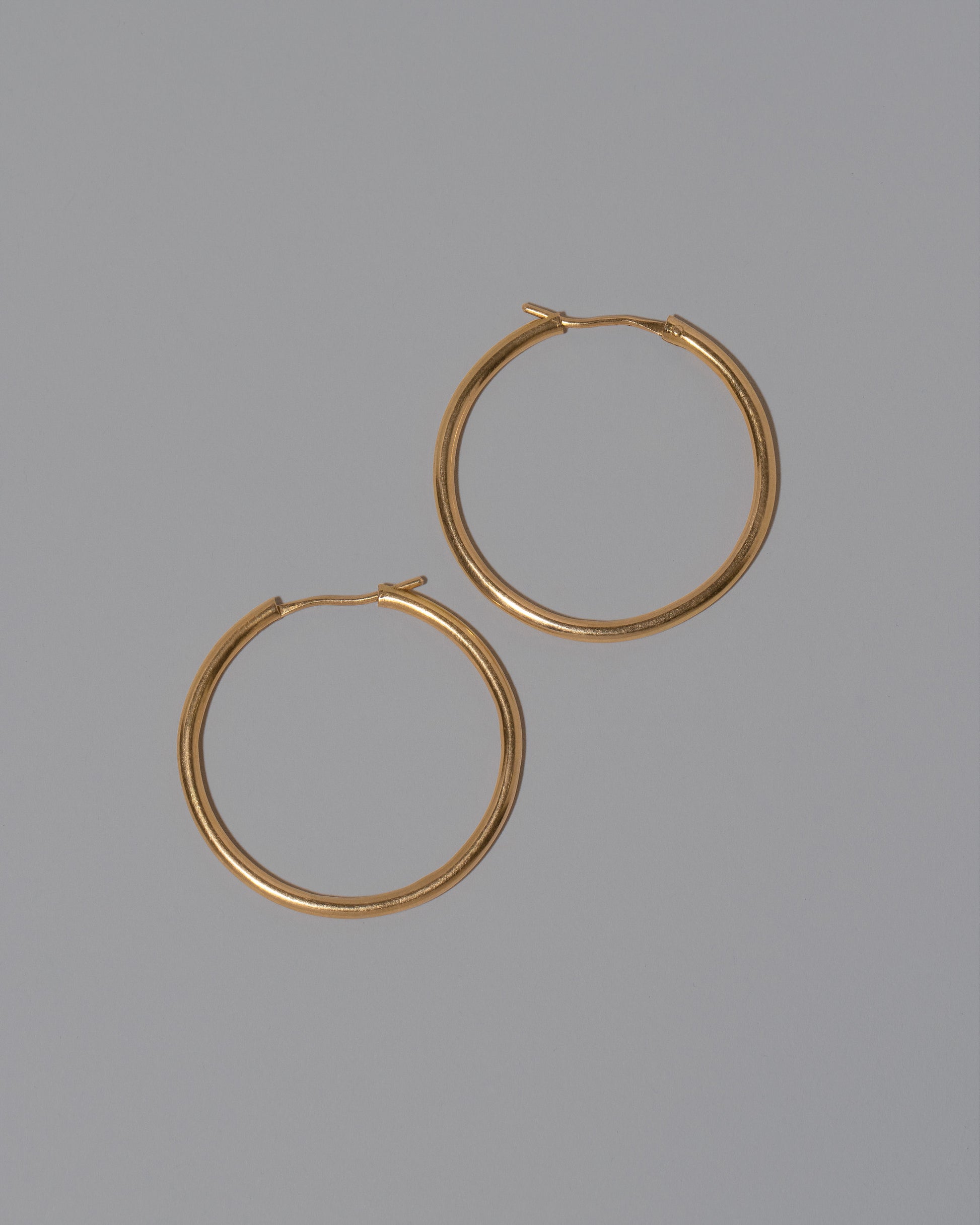 Vintage Blvgari Hoop Earrings on light color background.