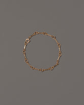 Bar Link Charm Chain Bracelet on light color background.