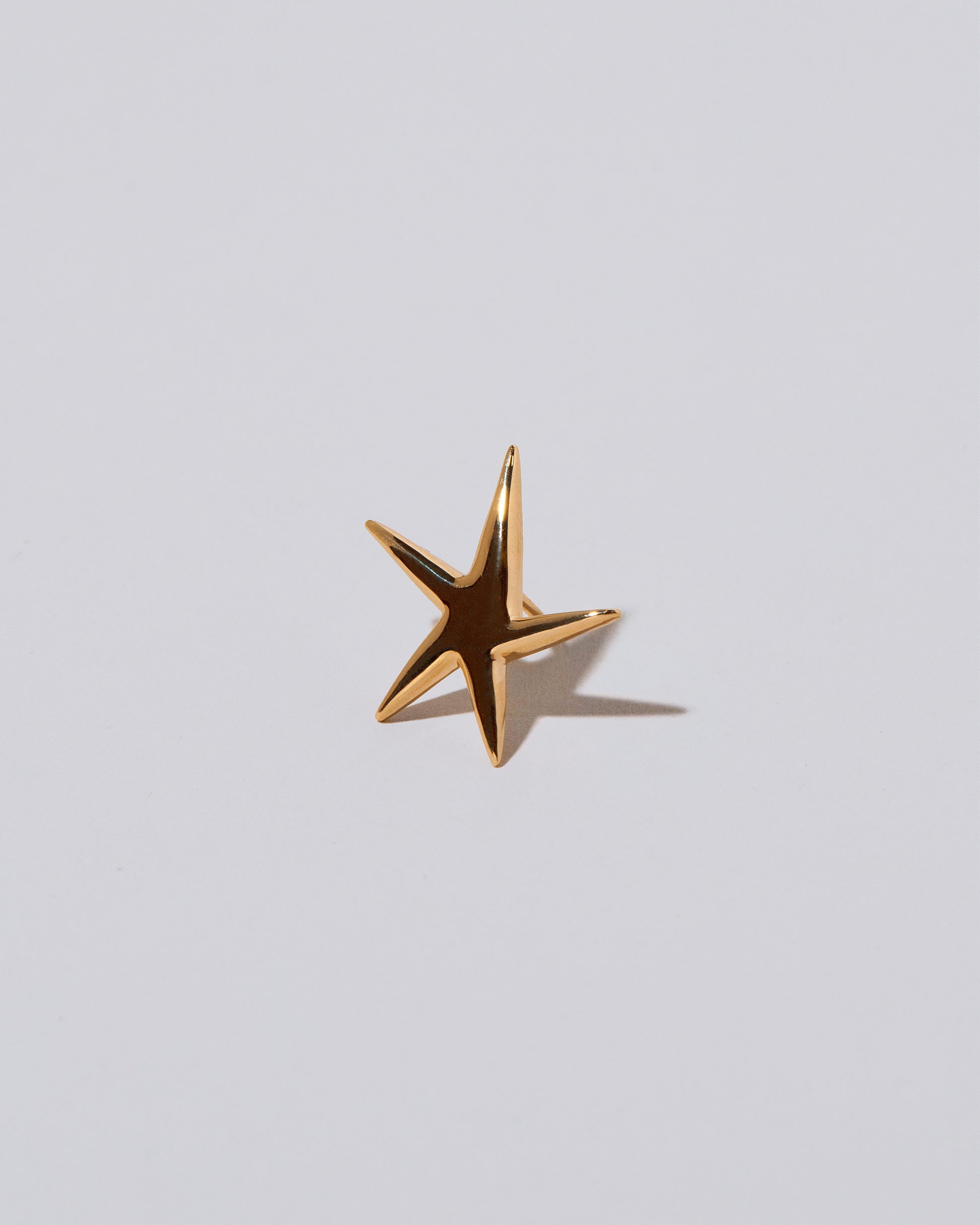 Verve Five Point Star Stud Earring on light color background.