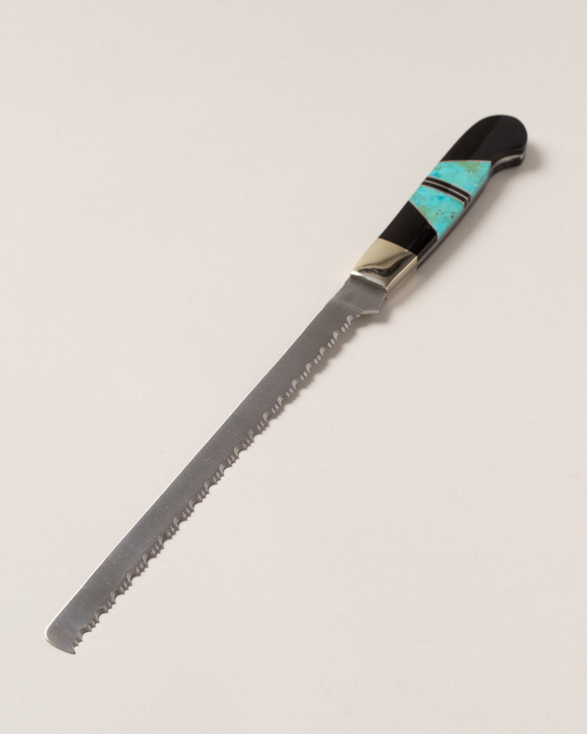 Santa Fe Stoneworks Jet & Turquoise Bread Knife on light color background.