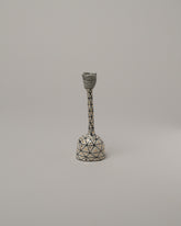 Suzanne Sullivan One Candlestick on light color background.