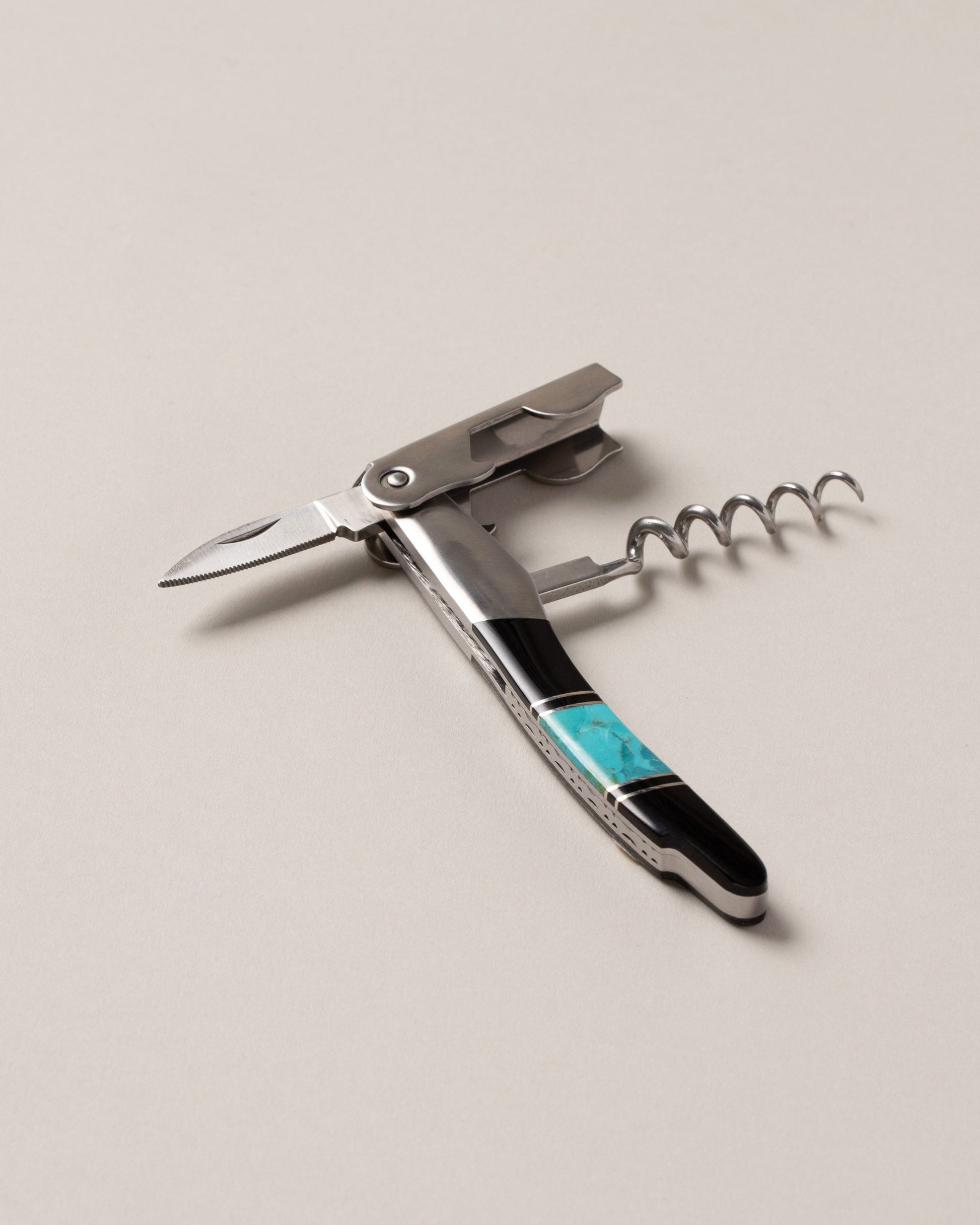 Santa Fe Stoneworks Turquoise and Jet Waiter's Knife on light color background.