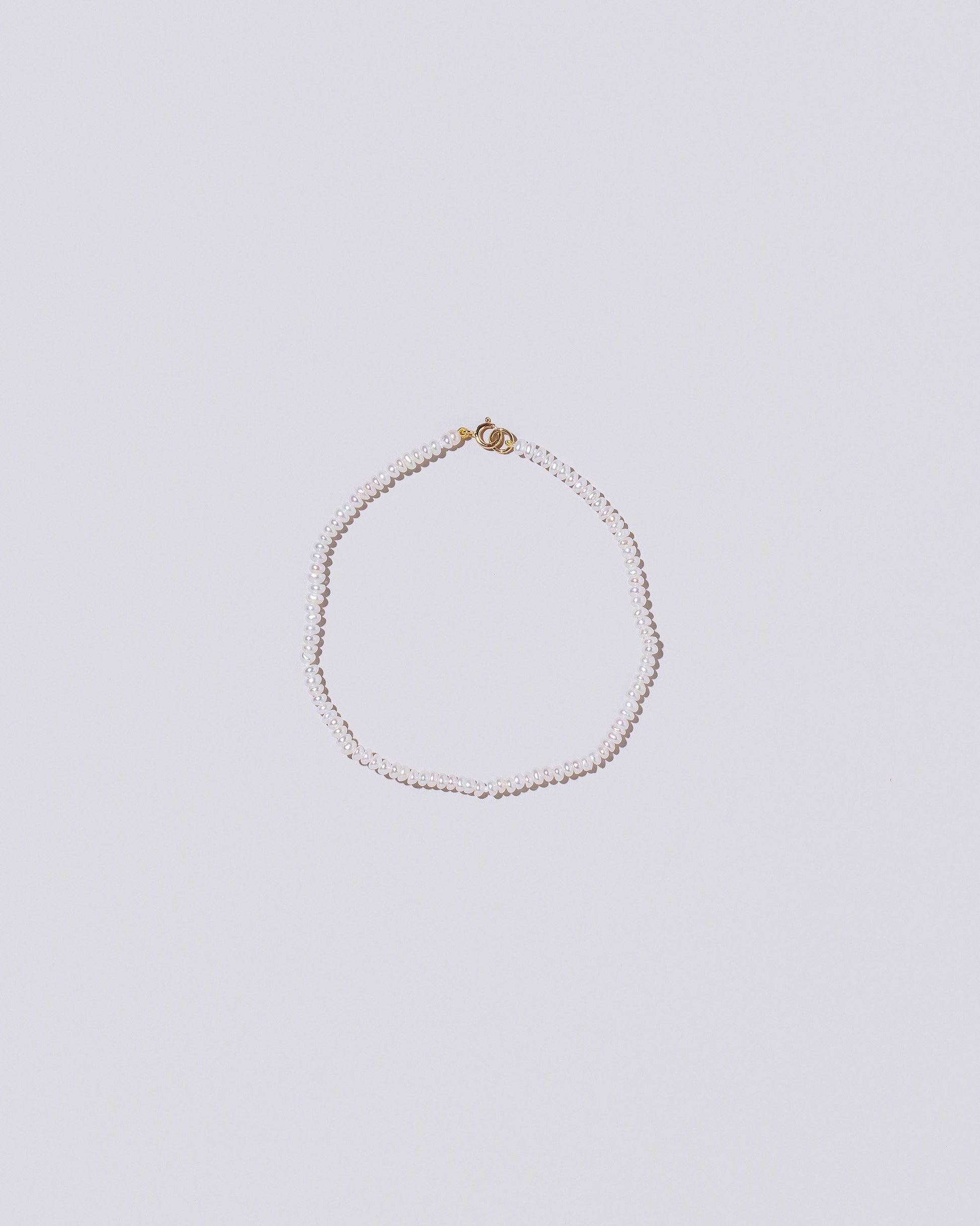 White Seed Pearl Bracelet on light color background.