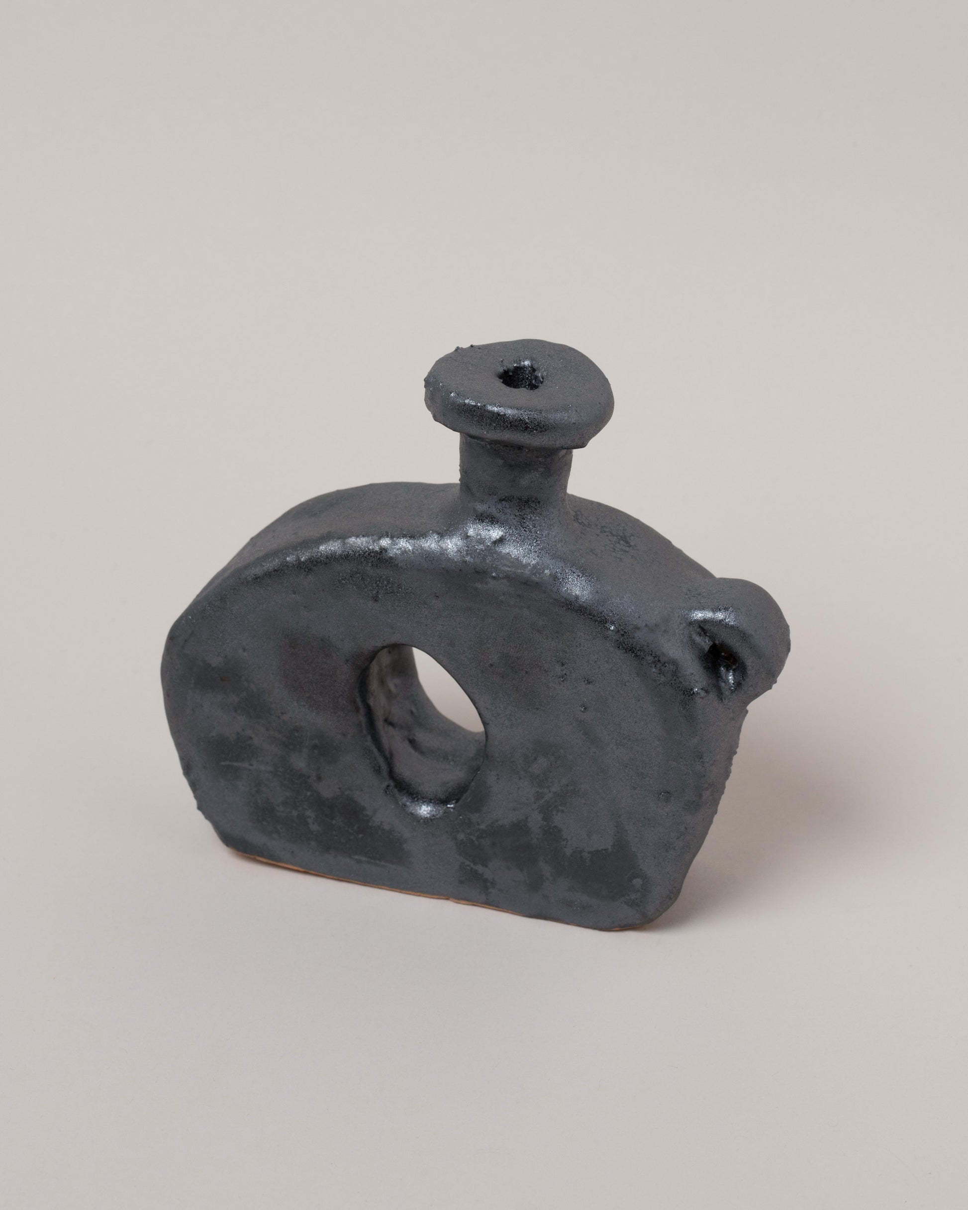 Closeup details of the Willem van Hooff Iridium Tiny Core Vessel on light color background.