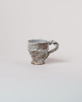 Wonky Ware Ceramics Icy Short Mug on light color background.