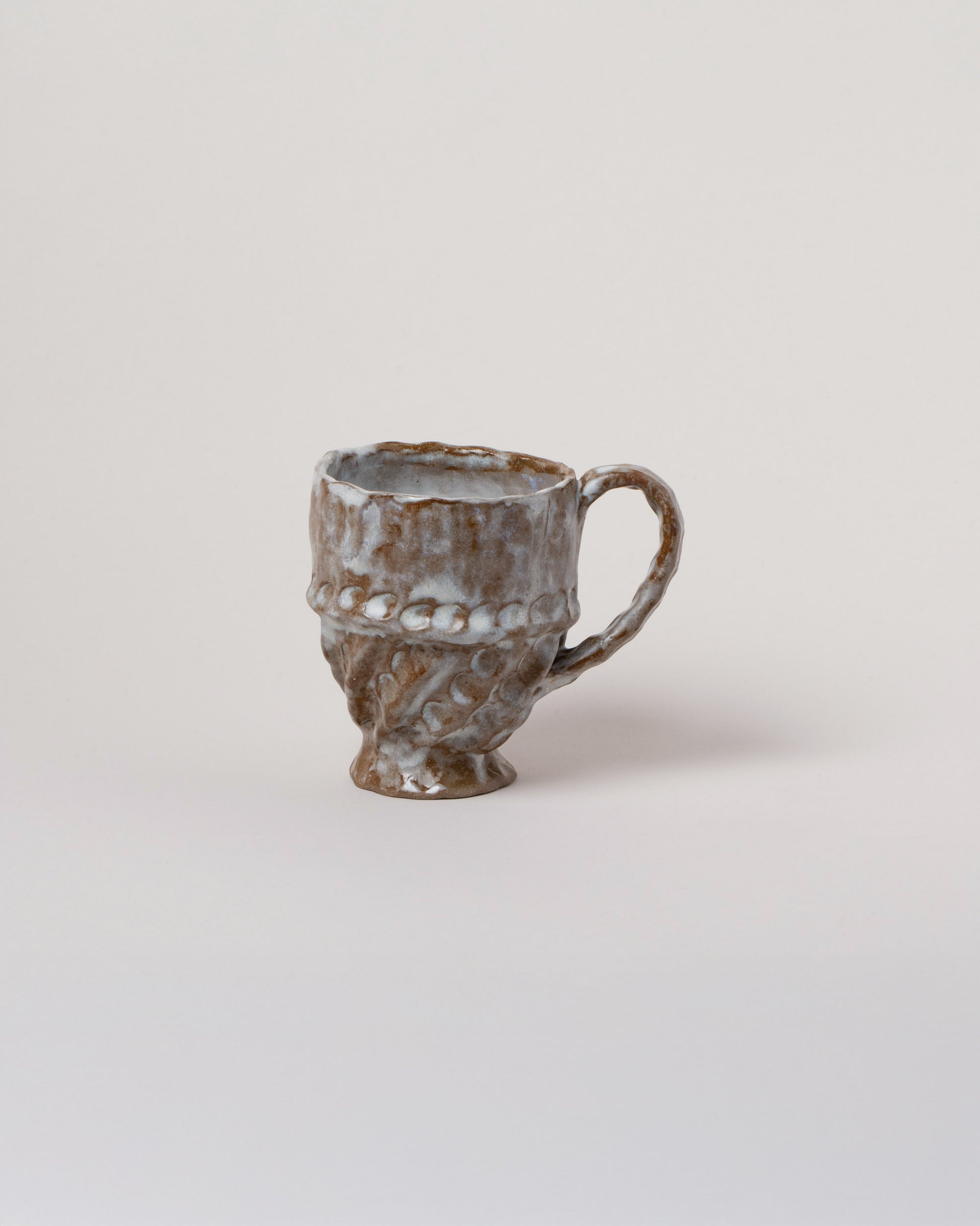 Wonky Ware Ceramics Icy Short Mug on light color background.