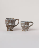 Wonky Ware Ceramics Icy Twist Mug and Icy Short Mug on light color background.
