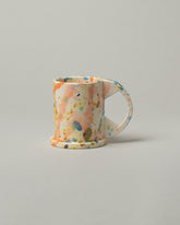 Echo Park Pottery by Peter Shire Tall Splatter Mug on light color background.