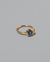 View from the side of the Blue Sapphire Level Ring on light color background.