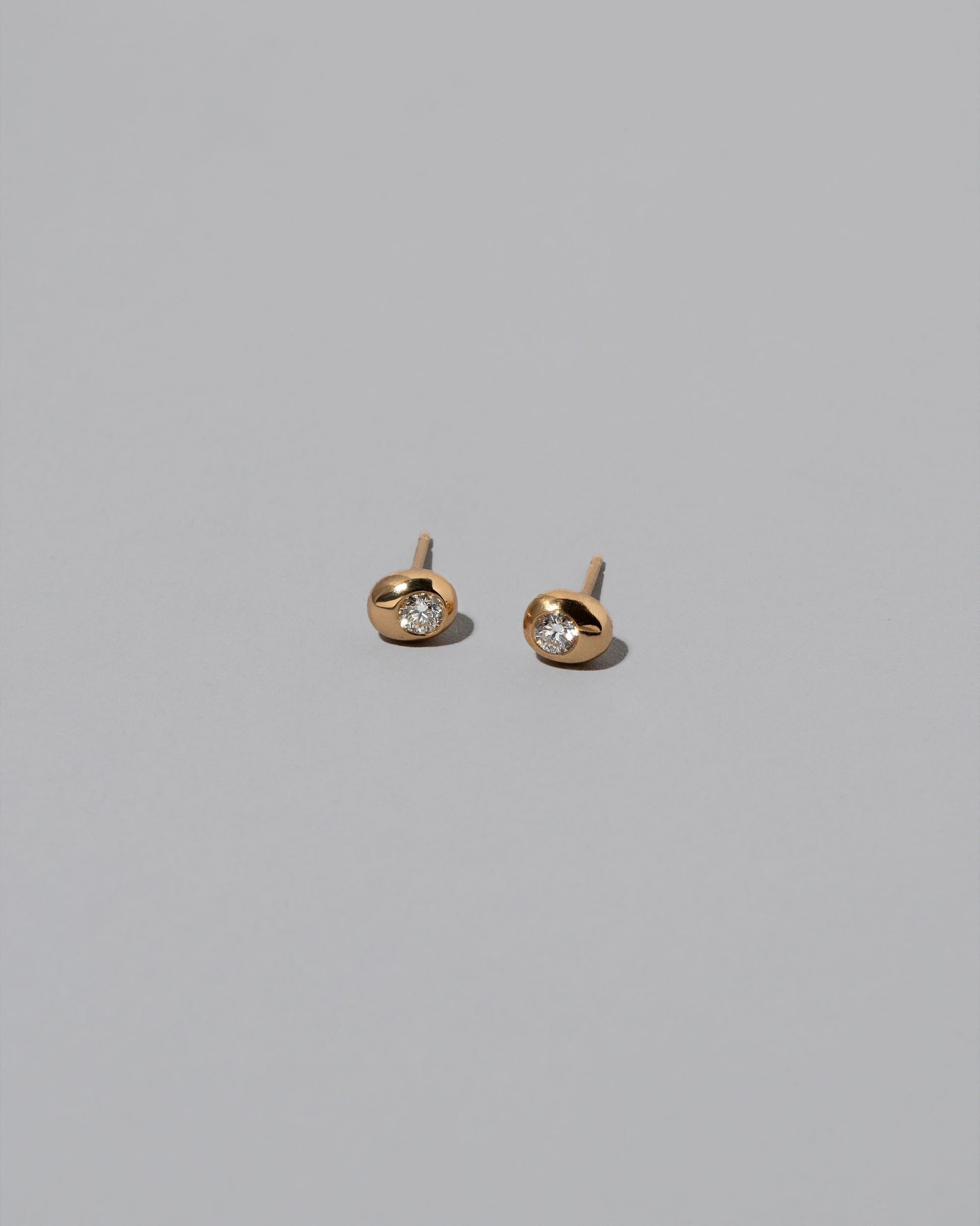 Diamond Birthstone Level Stud Earrings on light color background.