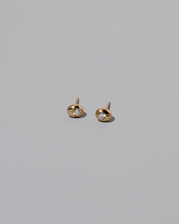 Diamond Birthstone Level Stud Earrings on light color background.