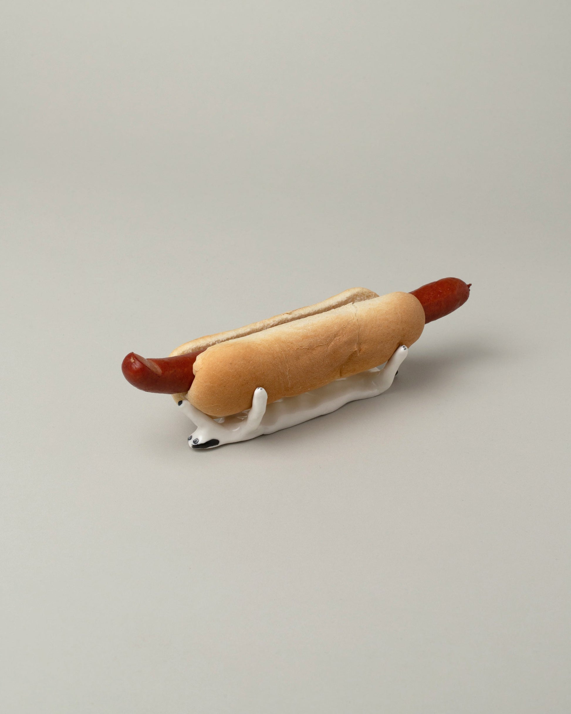 Detail view of the Eleonor Boström Hot Dog Rack on light color background.