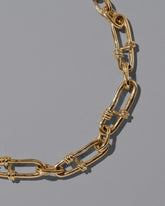 Closeup details of the CRZM 22k Gold Canyon Bracelet on light color background.