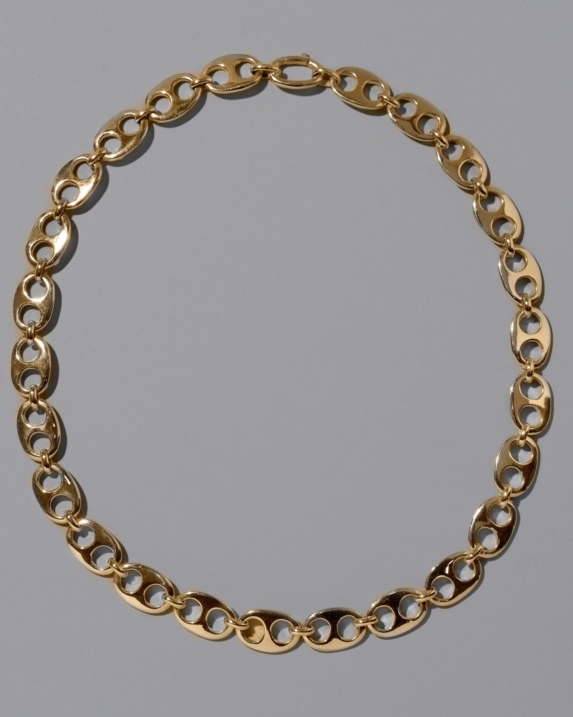 CRZM Gold Yuba Medium Necklace on light color background.