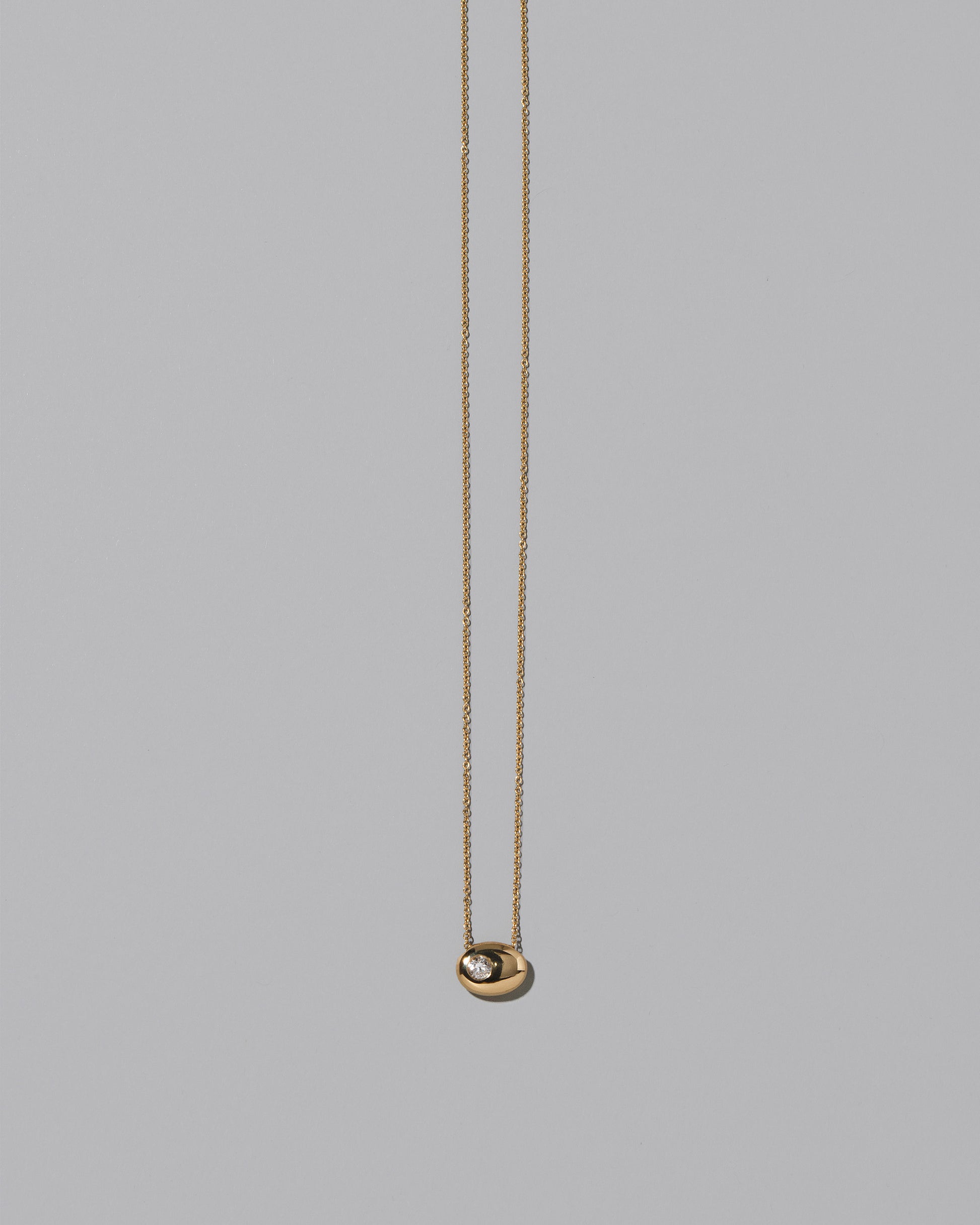 Gold Diamond Level Necklace on light color background.