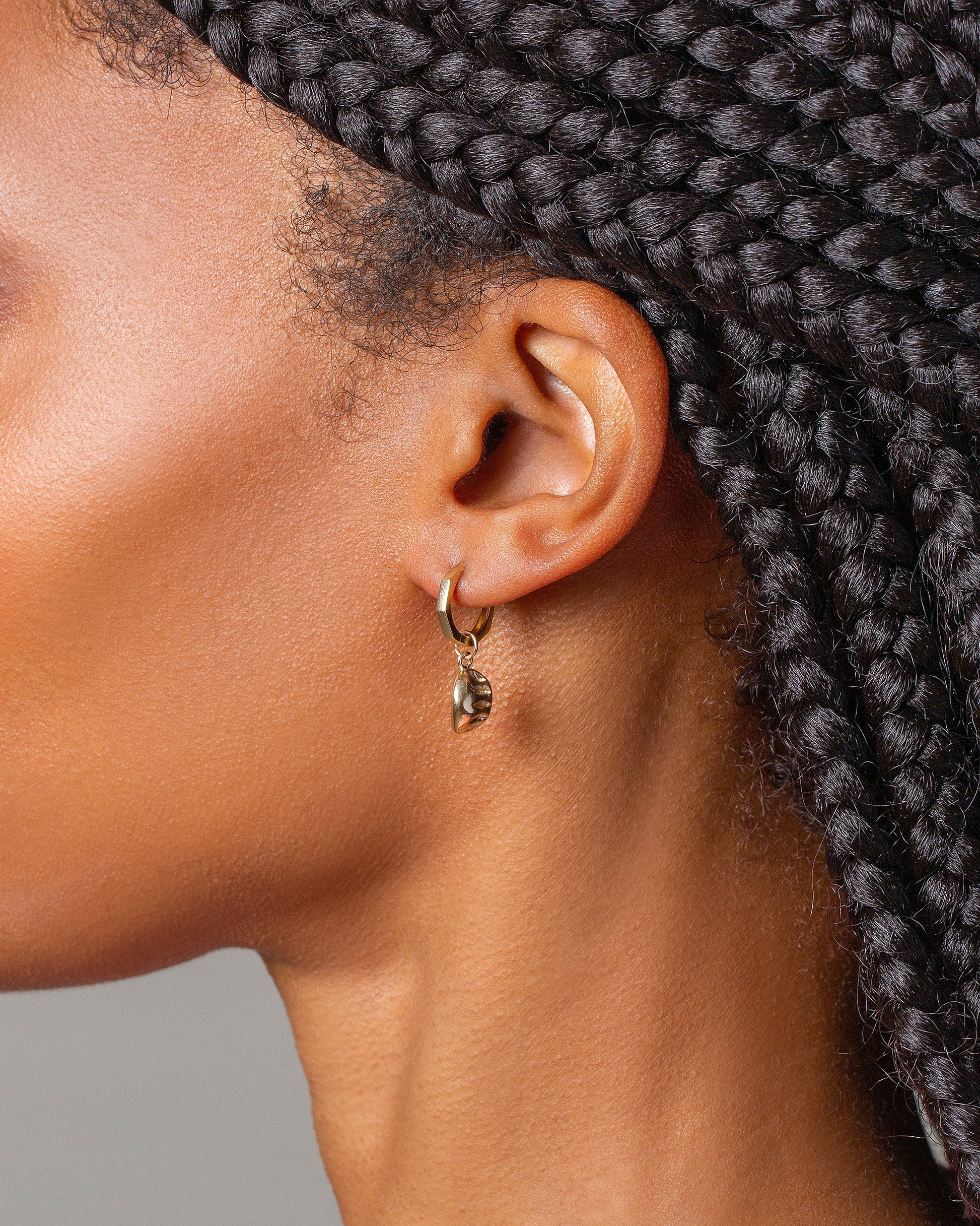 Steamed Dumpling Charm with Segmented Hoop Earrings on model.