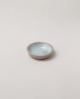 Humble Ceramics Greystone & Blue Celadon Mini Stillness Bowl on light color background.