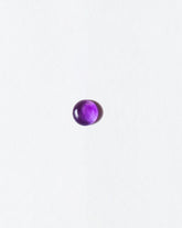 Amethyst cabochon on light color background.