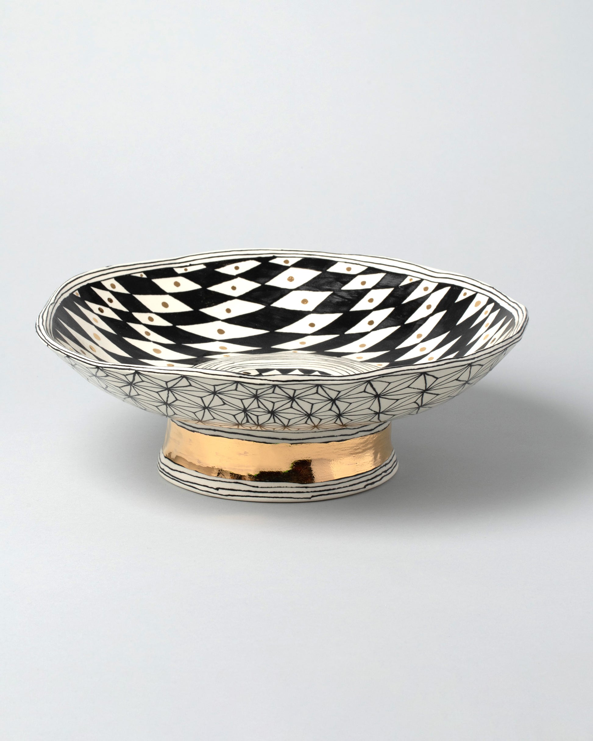 Suzanne Sullivan Two Footed Bowl on light color background.