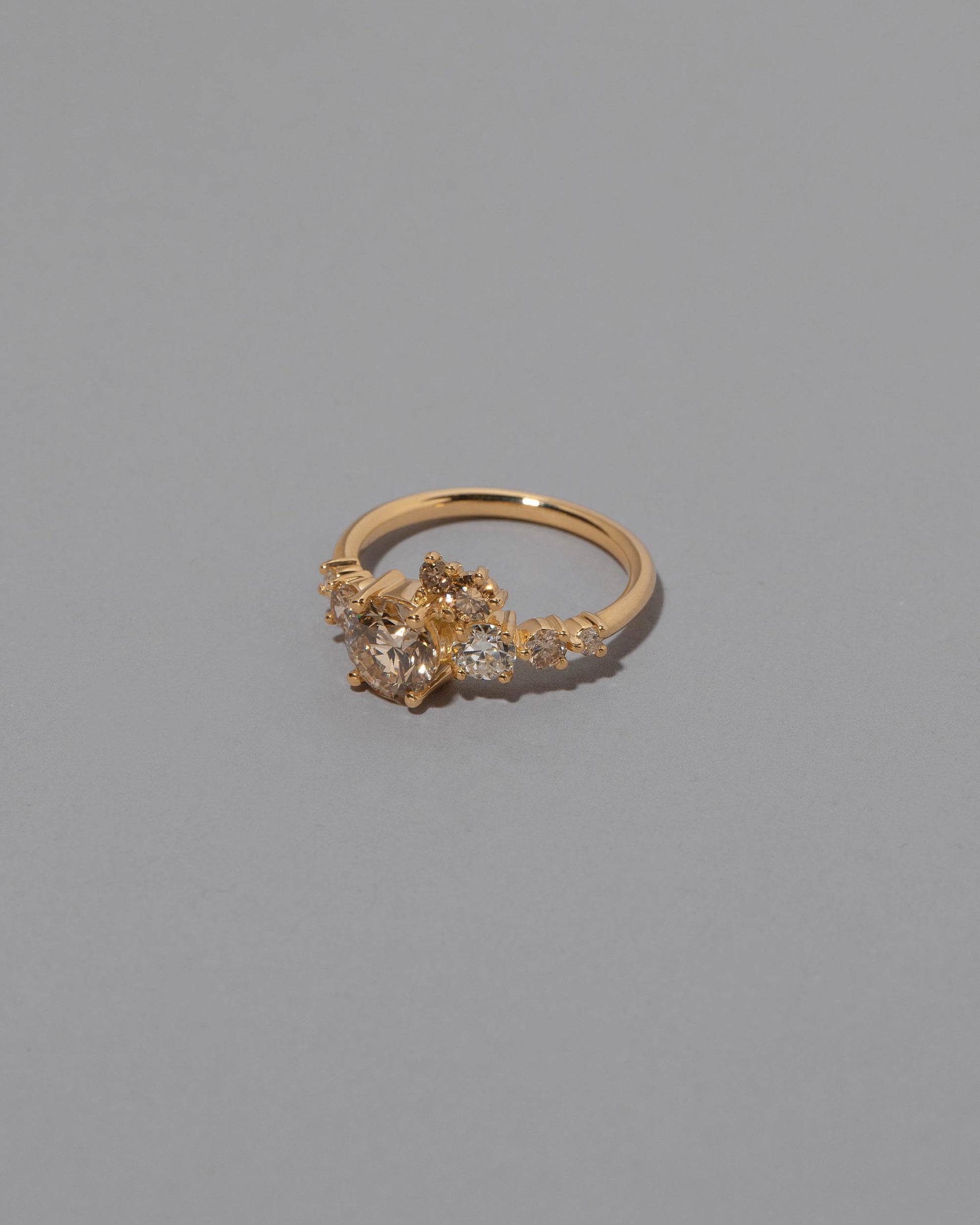 View from the side of the Champagne Diamond Luna Ring on grey color background.