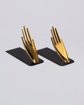 Carl Auböck Pair of Hands Brass Bookends Set on light color background.