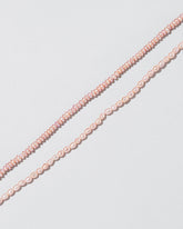 Closeup details of the Pink Peony Pebble Seed Pearl Choker Necklace & Pink Peony Oval Seed Pearl Choker Necklace on light color background.