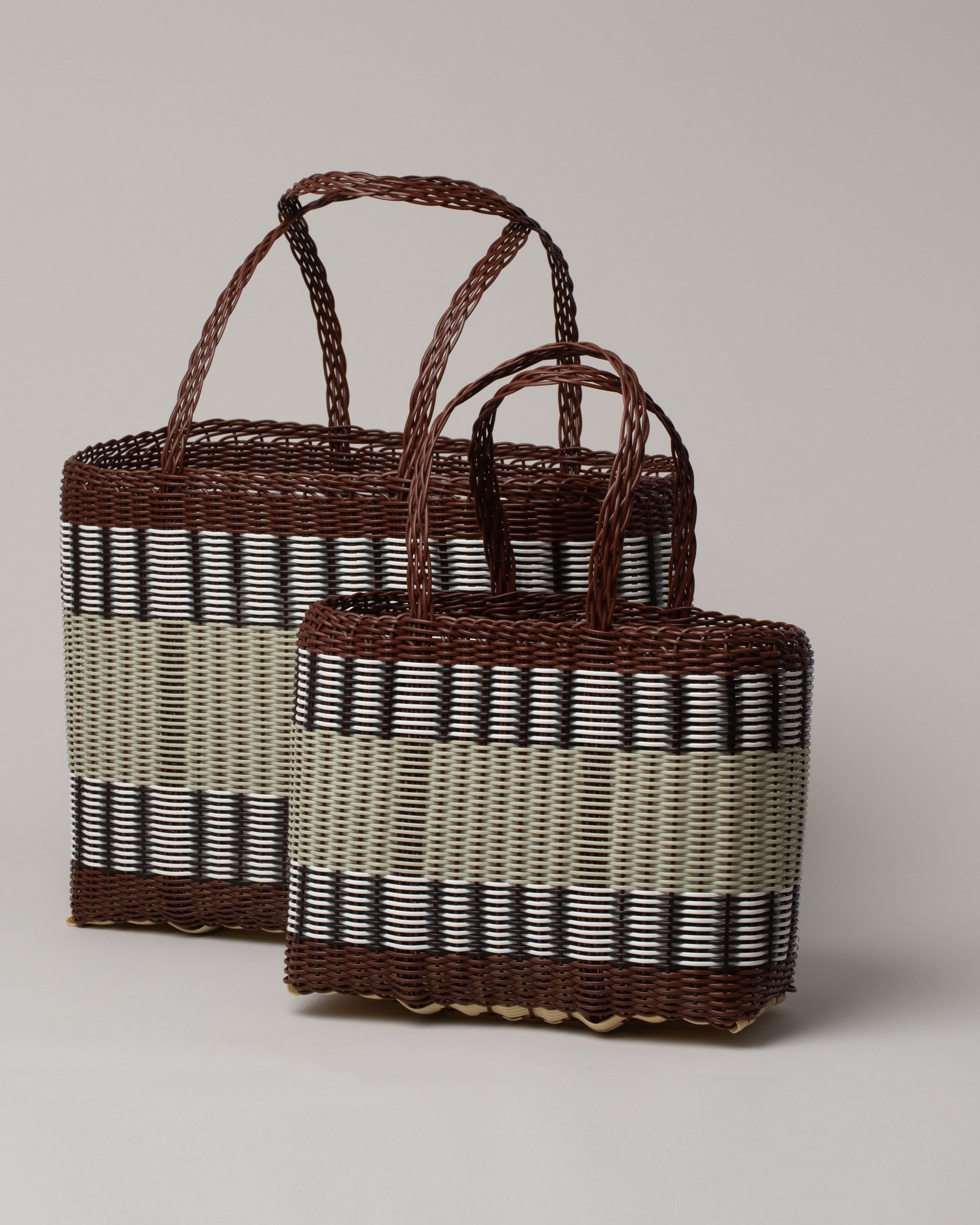 Group of Palorosa Chocolate & Palm Small and Medium Handwoven Mercado Basket Bags on light color background.