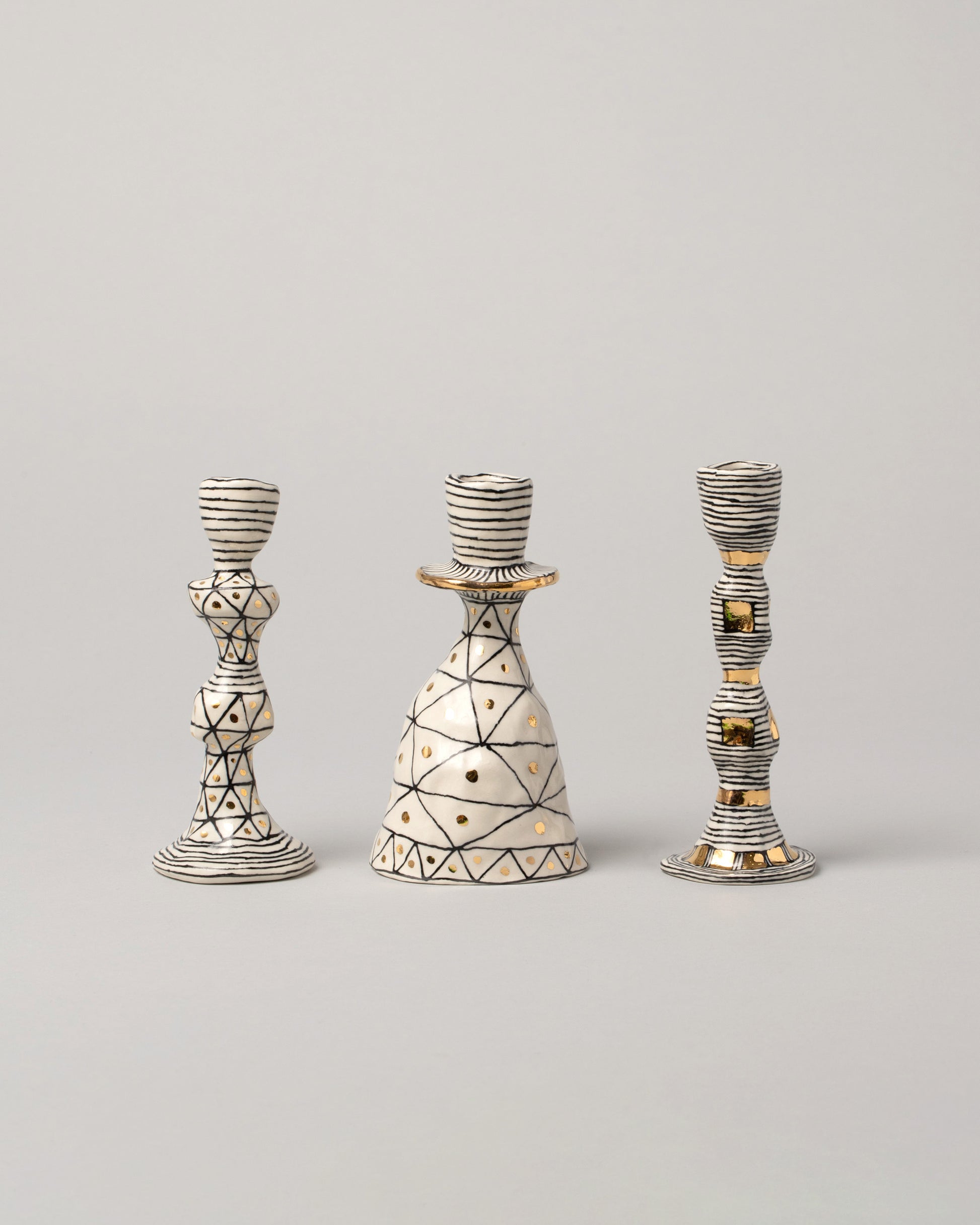 Group of Suzanne Sullivan Candleholders on light color background.