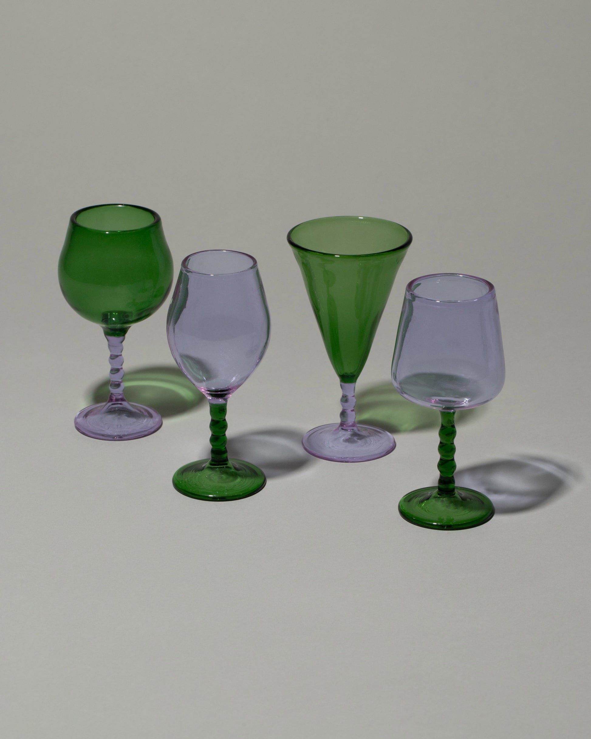 Closeup details of the Ornamental by Lameice Green & Lilac Dreamlike Liquor Glass Set on light color background.