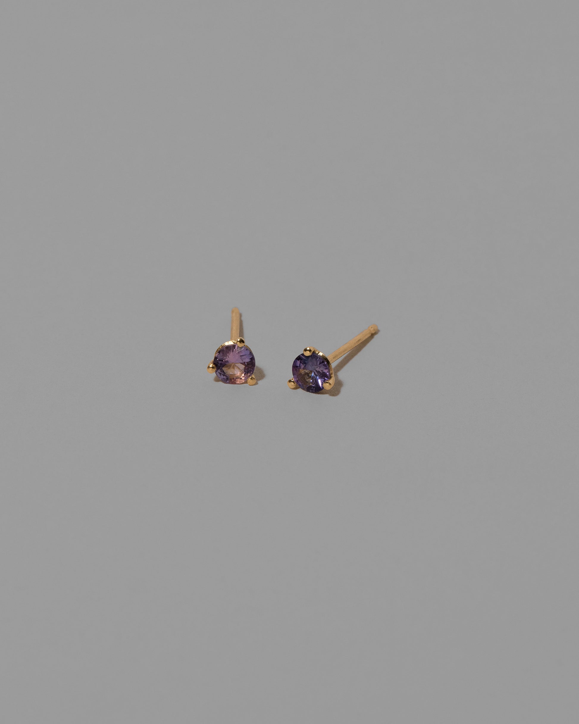 Lavender Sapphire Martini Stud Earrings on light color background.