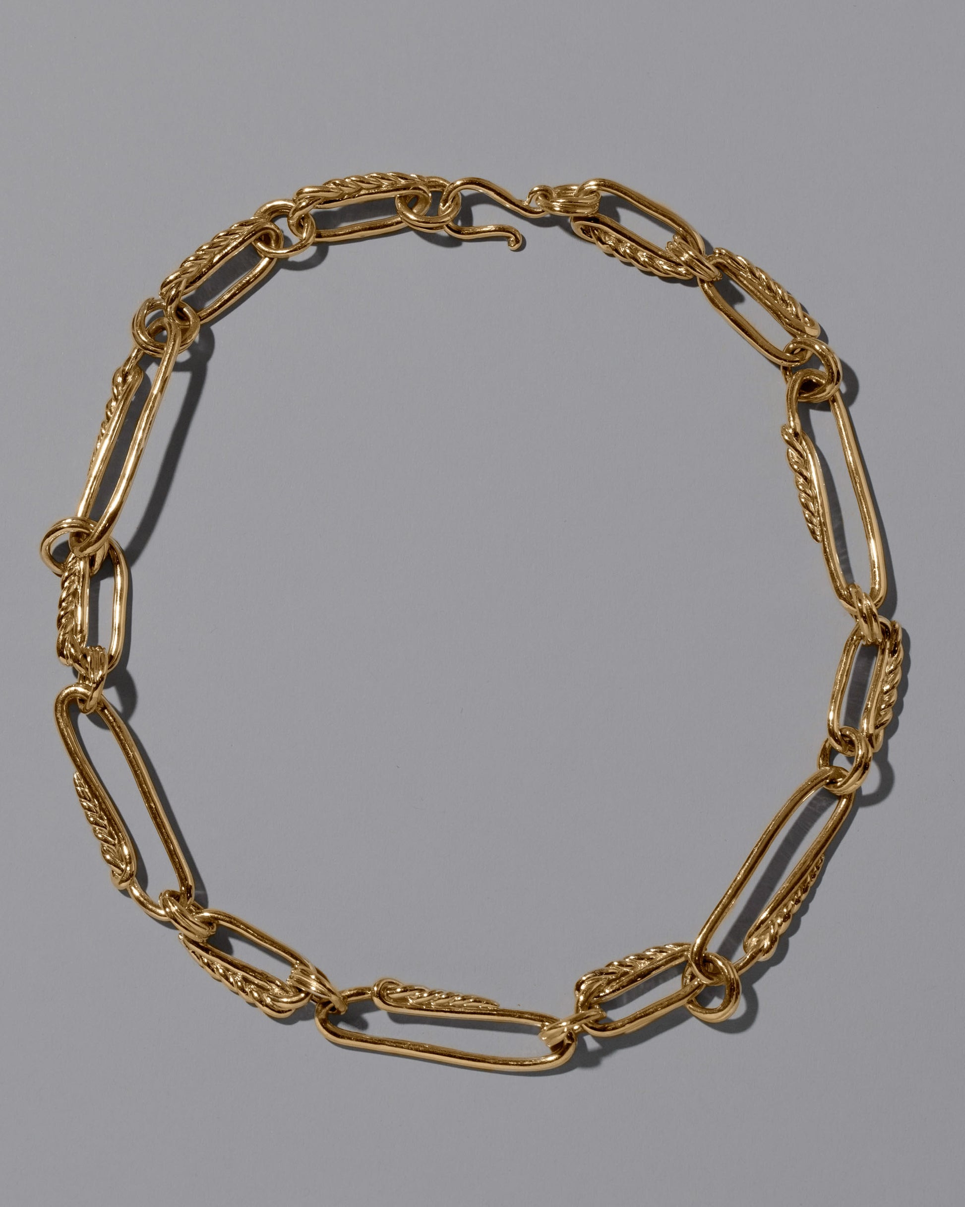 CRZM 22k Gold Ophiolite Necklace on light color background.