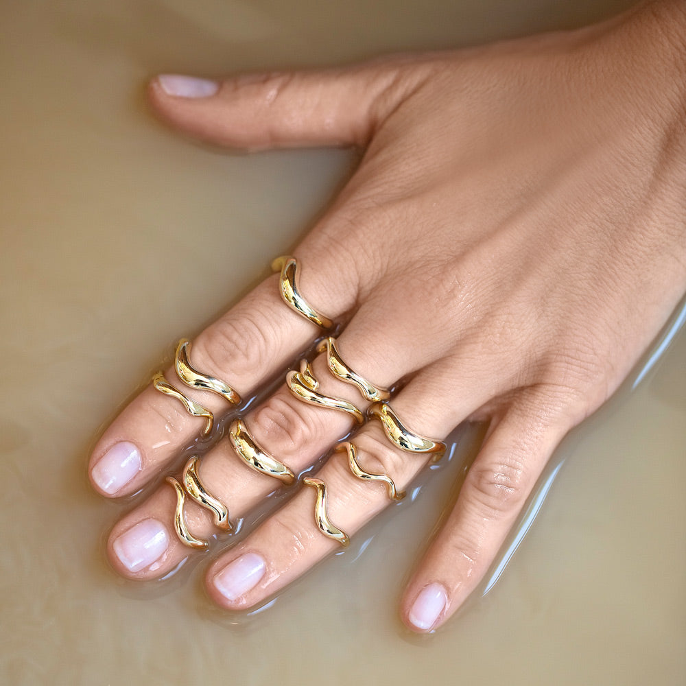 product_details::Group of Gold Bands from the Level Collection on model.