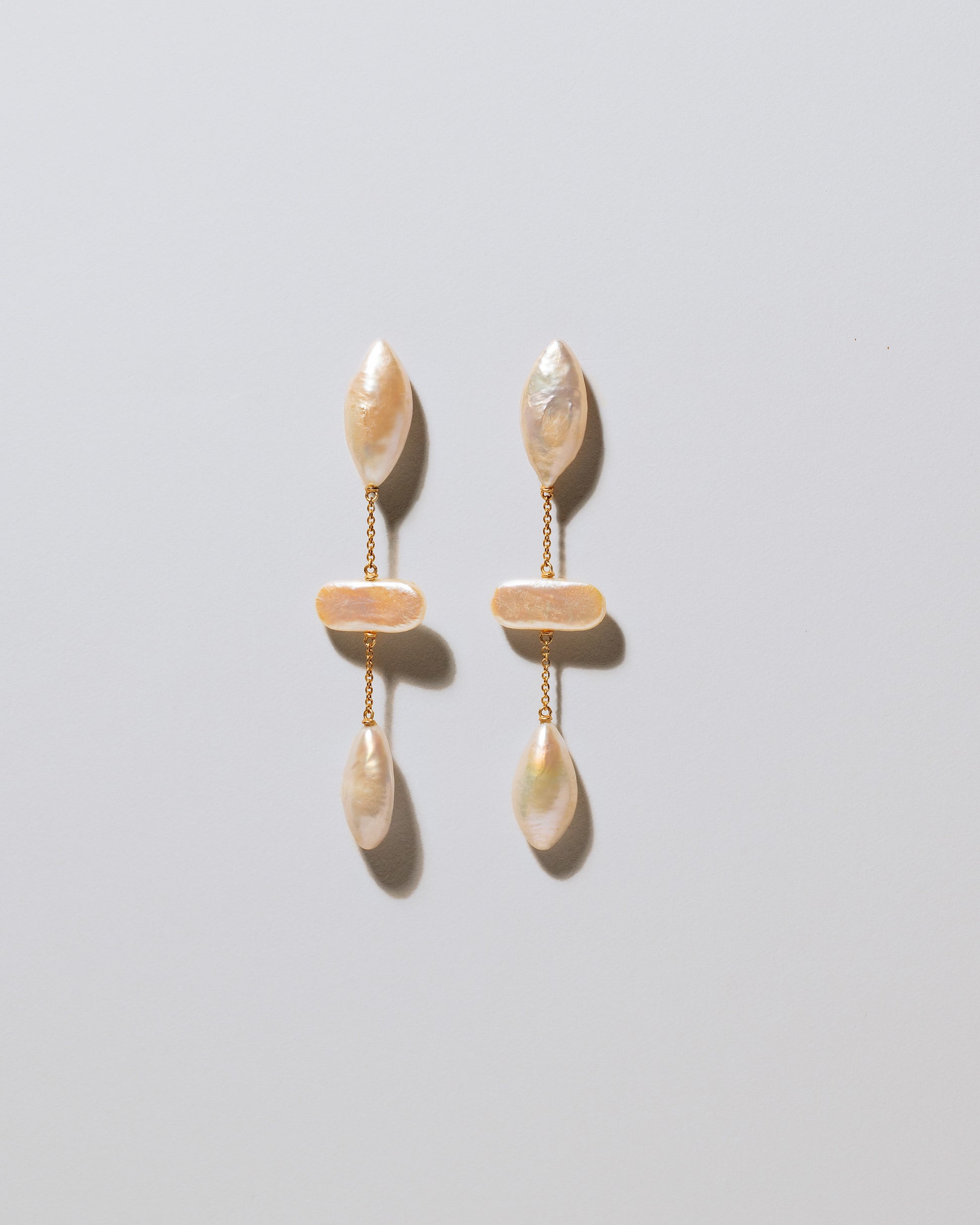 Osprey Pearl Earrings on light color background.