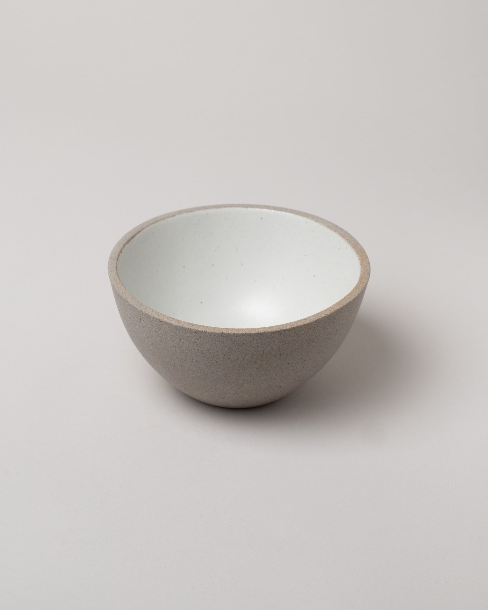 Humble Ceramics Greystone & Snow White Enoki Bowl on light color background.