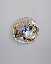 Silje Lindrup Yellow Glass Wall Clock on light color background.