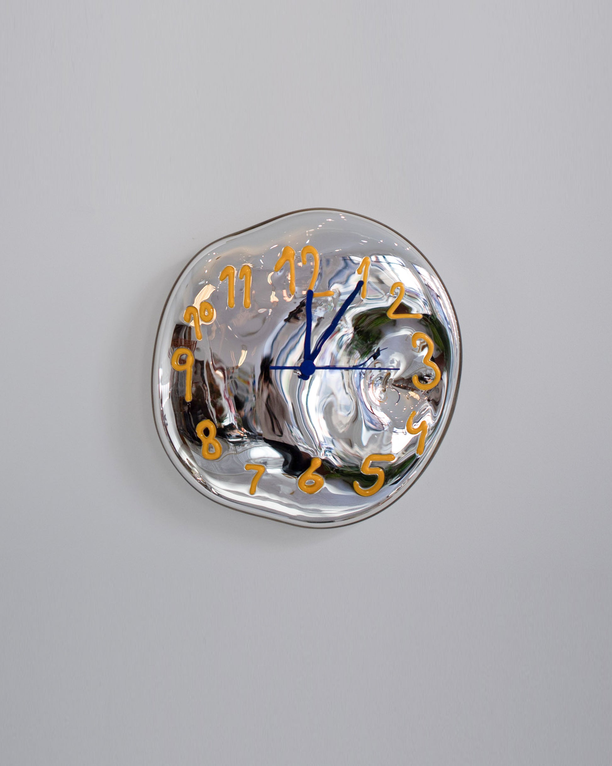 Silje Lindrup Yellow Glass Wall Clock on light color background.