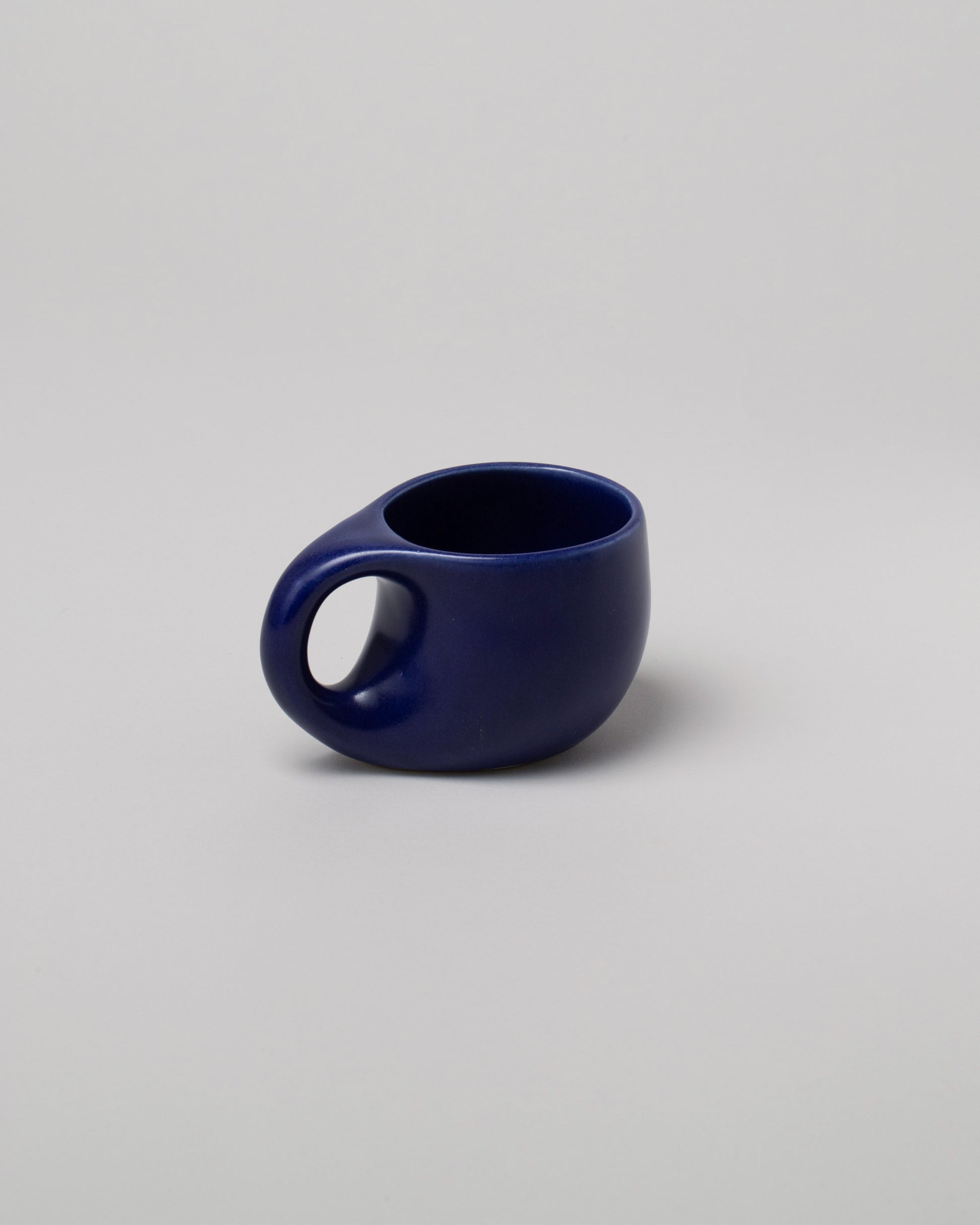 Dust and Form Small Deep Ocean Comfort Mug on light color background.