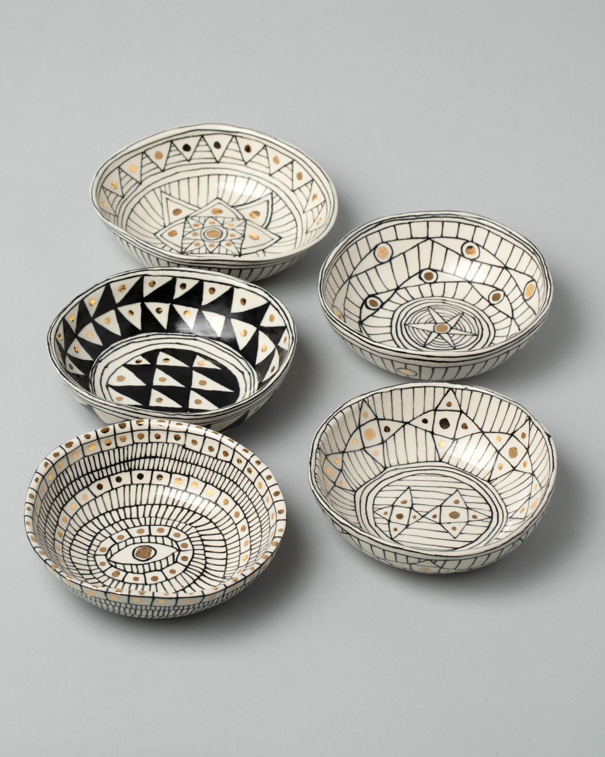 Group of Suzanne Sullivan Small Bowls on light color background.
