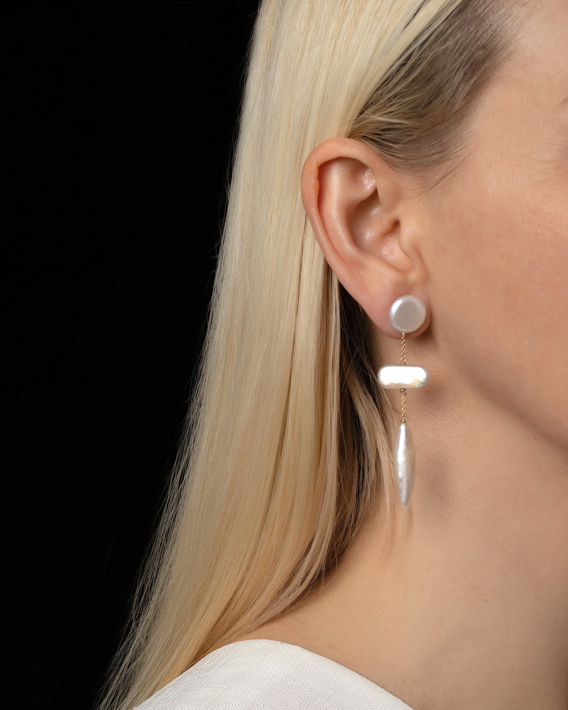 Heron Pearl Earrings on model.