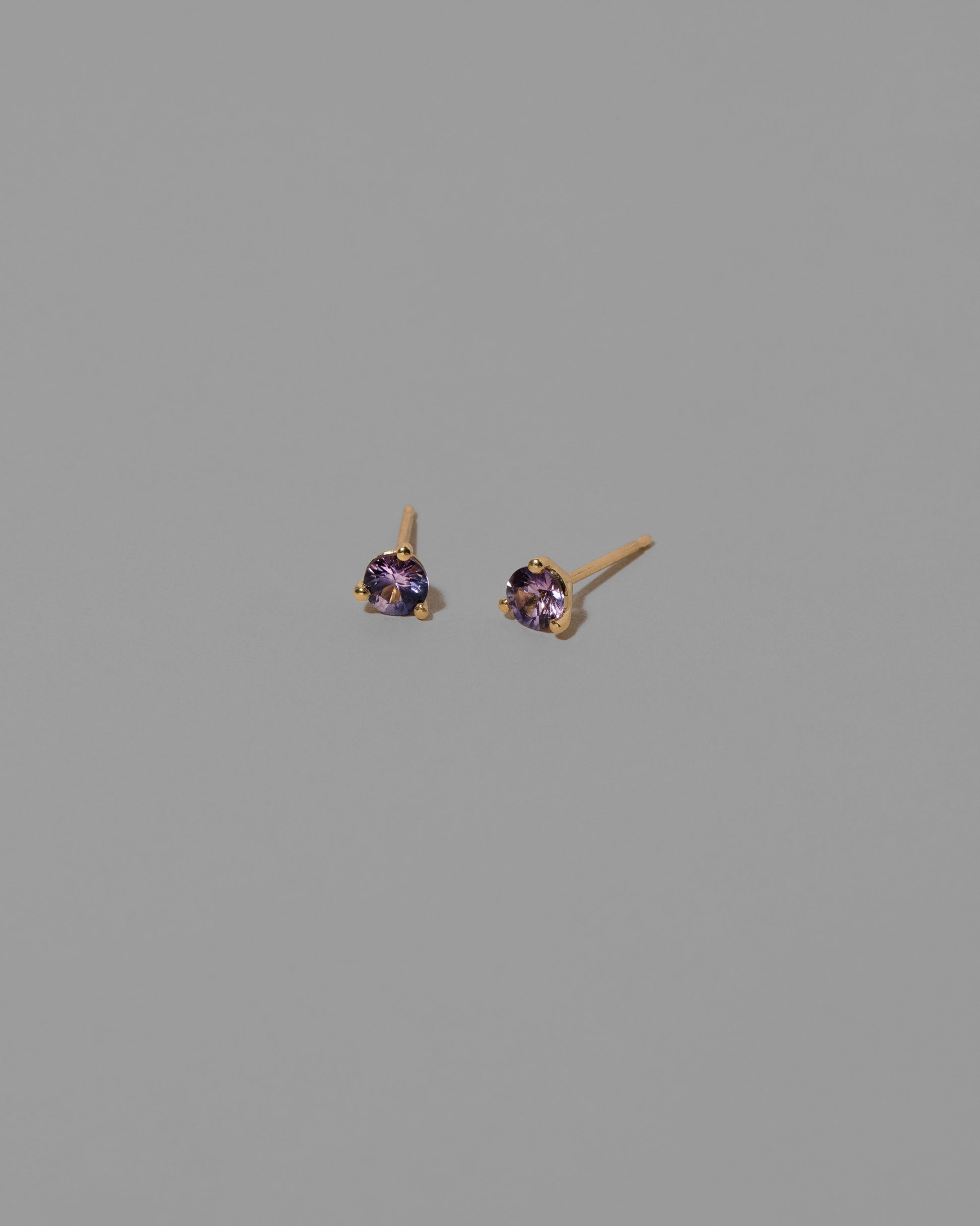 Petite Lavender Sapphire Martini Stud Earrings on light color background.