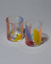 Group photo of Bow Glassworks Smiley Splash Cups on light color background.