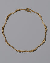 CRZM Gold Foothill Necklace on light color background.