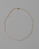 Half Oval Chain & Peony Seed Pearl Necklace on light color background.